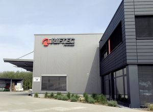 Leuchtbuchstaben am Gebäude von Riftec bei Tage: graue Buchstaben.
